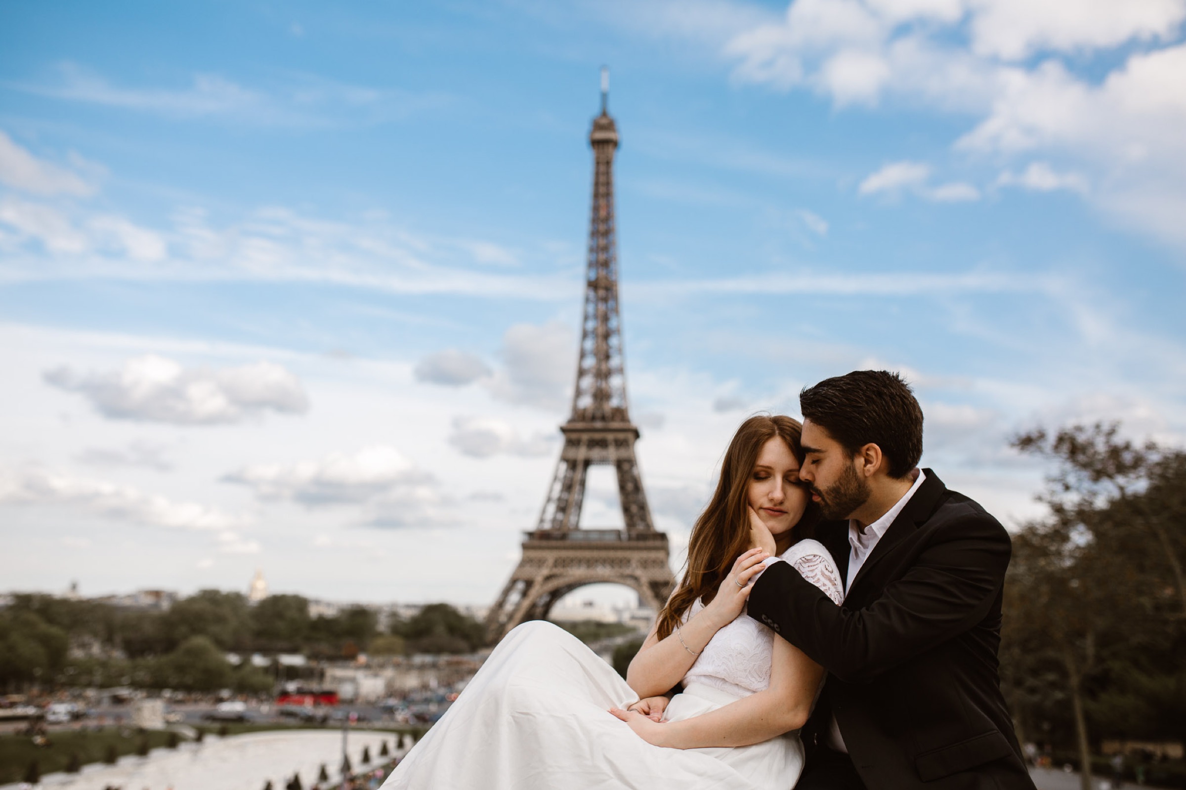 Paris — couple beneath the Eiffel Tower.